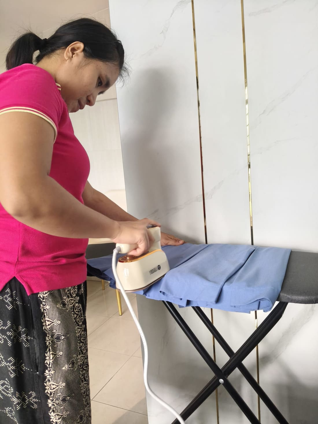Apex Maids helper ironing in a Singapore home
